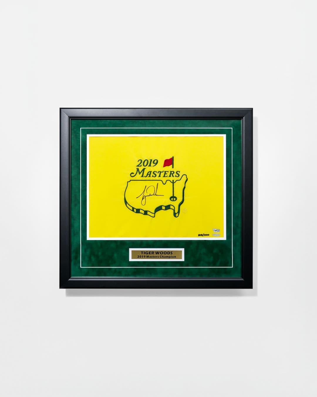 Framed yellow 2019 Masters flag autographed by Tiger Woods with green matting and plaque.